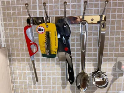 a group of kitchen utensils hanging on a wall at Casa Apartamento Valentina in Santo Domingo
