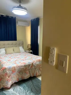 a bedroom with a bed and a light on the wall at Casa Apartamento Valentina in Santo Domingo