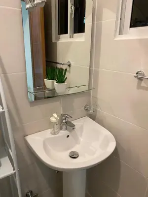 a bathroom with a white sink and a mirror at Casa Apartamento Valentina in Santo Domingo
