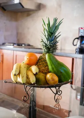 a plate of fruits and vegetables on a table at Central Area Bedroom With Common Kitchen, living room in Sosúa