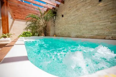 a bath tub with blue water in a room at Nice 1br-1bt With Common Picuzzi in Sosúa
