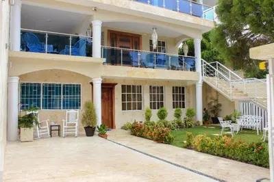 a house with a balcony and a patio at Nice 1br-1bt With Common Picuzzi in Sosúa