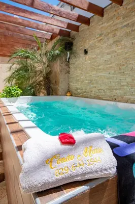 a pool with a towel sitting on top of it at Cozy 1bd with common Jacuzzi in Sosúa