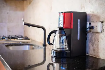 a coffee maker sitting on top of a counter at Central 1bd and Bth with common Picuzzi in Sosúa