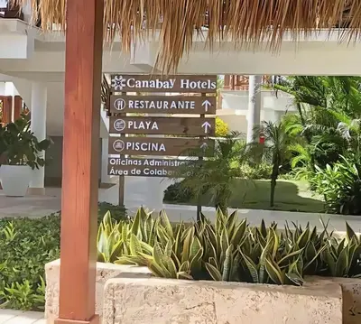 a sign in the lobby of a resort with plants at Cana Rock Star, Vista al campo de golf y Piscina C-303, B-400, B-506 y B-502 - Desayuno in Punta Cana