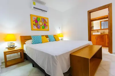 a bedroom with a large white bed in a room at Stella Aparthotel, Las Terrenas in Las Terrenas