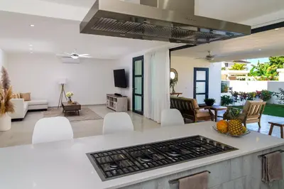 a kitchen and living room with a stove top at Stella Aparthotel, Las Terrenas in Las Terrenas