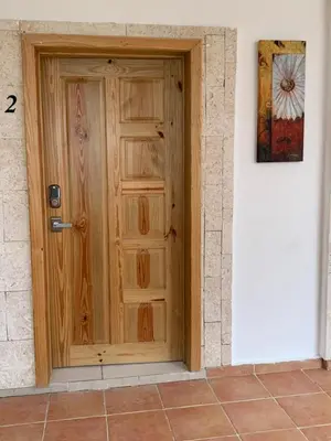 a wooden door in the side of a building at Noe Hotel ,1 Bed Room 2 Near to the beach in Punta Cana