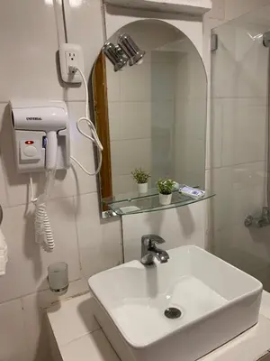 a bathroom with a white sink and a mirror at Noe Hotel ,1 Bed Room 2 Near to the beach in Punta Cana