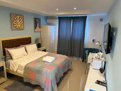 a bedroom with a bed and a television in it at Noe Hotel , One Bed Room Close to The beach Room #1 in Punta Cana