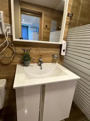 a bathroom with a white sink and a mirror at Noe Hotel , One Bed Room Close to The beach Room #1 in Punta Cana