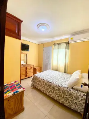 a bedroom with a bed and a television in it at Hospedaje Villa Valencia en Los Patos in Los Patos