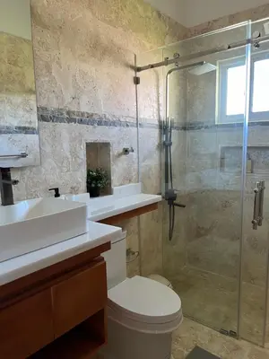 a bathroom with a shower and a toilet and a sink at Villa 102A, 5 master bedroom and 5 full bathrooms with private pool in Sosúa