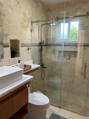 a bathroom with a shower and a toilet and a sink at Villa 102A, 5 master bedroom and 5 full bathrooms with private pool in Sosúa