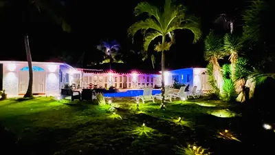 an image of a house at night with lights at PALM HOUSE - LUXURY VILLA - SAMANÁ - Ocean Front in Sánchez