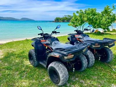 two atvs parked on the grass near the beach at PALM HOUSE - LUXURY VILLA - SAMANÁ - Ocean Front in Sánchez