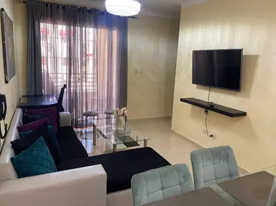 a living room with a couch and a tv at Lesnah Apartamento, Jacobo Majluta in Los Casabes