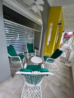 a room with chairs and a table and a window at Hotel Unico in Santo Domingo