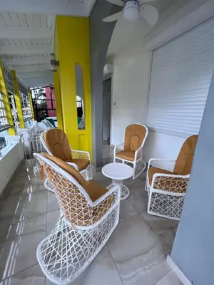 a group of chairs and tables in a room at Hotel Unico in Santo Domingo