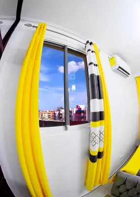 a bus with yellow and black curtains and a window at Apartamento en la carreras próximo al monumento in Santiago de los Caballeros