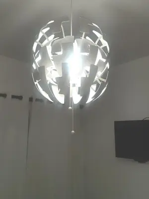 a chandelier hanging from the ceiling in a room at Comodas 3 Habitaciones, Wifi 1er piso in Santiago de los Caballeros
