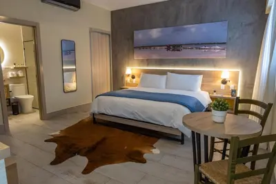 a bedroom with a large bed and a table with a table sidx sidx at Casa Adefra Boutique Hotel Zona Colonial in Santo Domingo