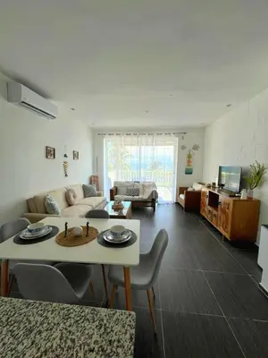 a living room with a couch and a table at Perfect Paradise, Oceanview in Samana in Santa Bárbara de Samaná