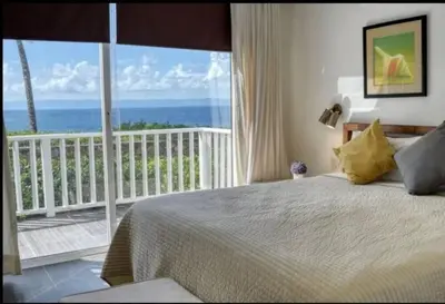 a bedroom with a bed and a view of the ocean at Perfect Paradise, Oceanview in Samana in Santa Bárbara de Samaná