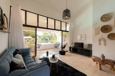 a living room with a blue couch and a table at Flat Anchor Marine Monte Vista in Sosúa