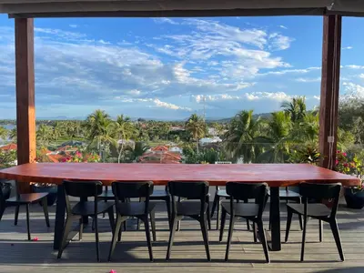 a table and chairs on a deck with a view at Ultravioleta Boutique Residences in Cabarete