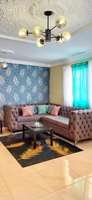 a living room with a couch and a table at Casa familiar in San Pedro de Macorís