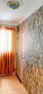 a room with a wall with a curtain and a door at Casa familiar in San Pedro de Macorís