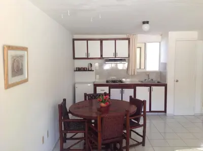 a kitchen and dining room with a table and chairs at La Punta Apartamentos in Cabarete