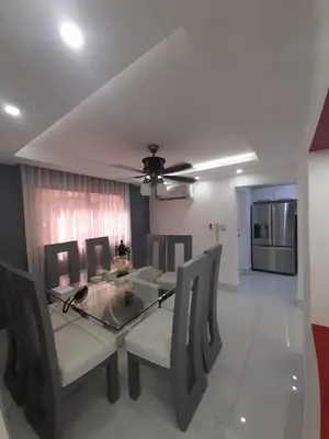 a dining room with a glass table and chairs at Hermoso apartamento Residencial madera I in Santiago de los Caballeros