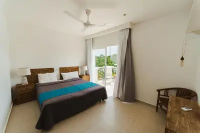 a bedroom with a bed and a large window at Private Villa LaPerla Iberosta 3BDR, Pool, Beach, WiFi in Punta Cana
