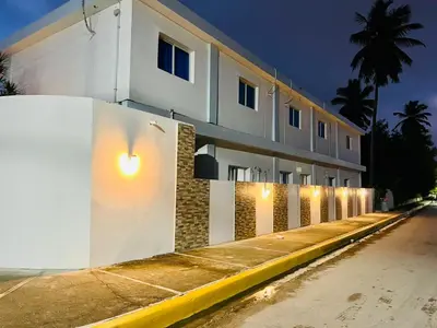 a white building with lights on the side of it at Noé Hotel ,1 Bedroom # 5 near to the beach in Punta Cana