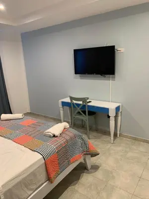 a room with a desk and a tv on a wall at Noé Hotel ,1 Bedroom # 5 near to the beach in Punta Cana