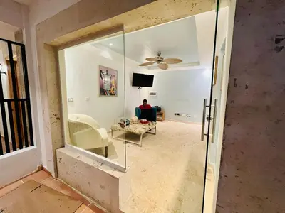 a living room with a ceiling fan and a glass door at Noé Hotel ,1 Bedroom # 5 near to the beach in Punta Cana