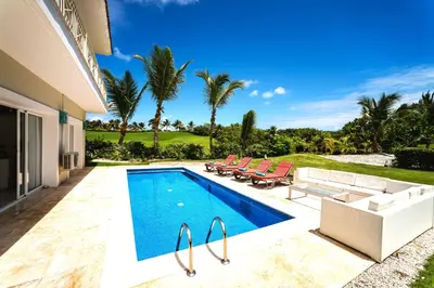 a swimming pool in the backyard of a house at Private Iberosta Villa Fortuna - 4BDR, Pool & Private Beach in Punta Cana