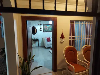 a living room with a couch and a chair at Hermosa casa urbanización Jardines del Norte in Santiago de los Caballeros