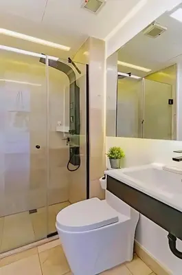 a bathroom with a toilet and a sink and a shower at Cana Rock Condos Familiar - Two apartments very close-Ground floor direct access to the pool in Punta Cana