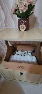 a box with a vase of flowers on a shelf at La Casita de Mary in Santa Cruz de Barahona
