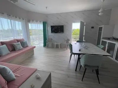 a living room with a couch and a dining room table at Apartamentos La Torre in Río San Juan