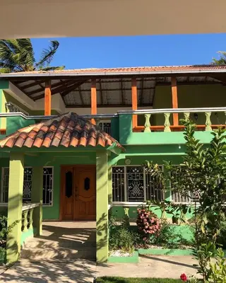 a green house with a red roof at Villa La Esperanza in Nizao