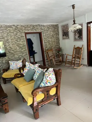 a living room with a couch and a mirror at Villa La Esperanza in Nizao