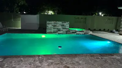 a swimming pool at night with a green illumination at Villa La Esperanza in Nizao