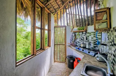 a kitchen with a sink and windows in a house at Tropical Cottage En Eco Casa Algana in El Limón