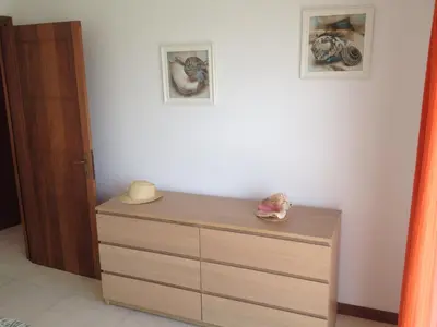 a dresser in a room with two pictures on the wall at Maggy's House in La Romana
