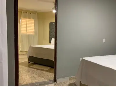 a mirror reflection of a bedroom with a bed in a room at Glamour Hotel in La Romana