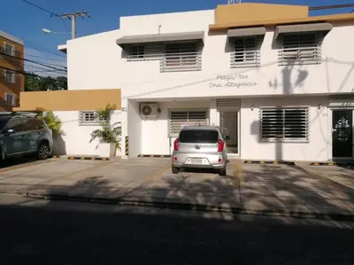 a silver car parked in front of a white building at Studio in Los Jardines Sleeps 2 in Santo Domingo